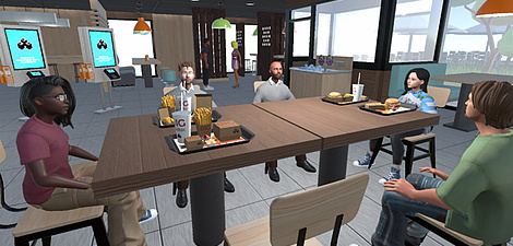 Ein Bild aus einer Computersimulation. Ein Tisch in einem Kaffeehaus, an dem fünf Menschen sitzen. Es stehen Getränke und Essen auf dem Tisch.