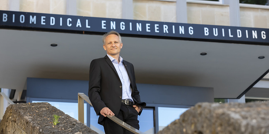 A man is standing on a staircase.