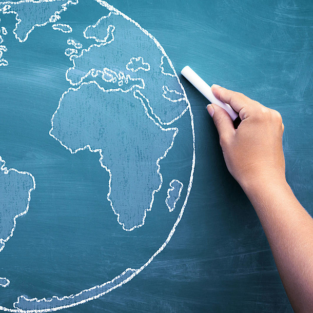Globe illustrated with chalk on a board. Photo source: Cherries - Fotolia.com