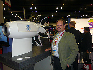 Dr. Emil Göttlich with a model of an open rotor jet engine at the exposition of the ASME Turbo Expo 2011 in Vancouver, Canada