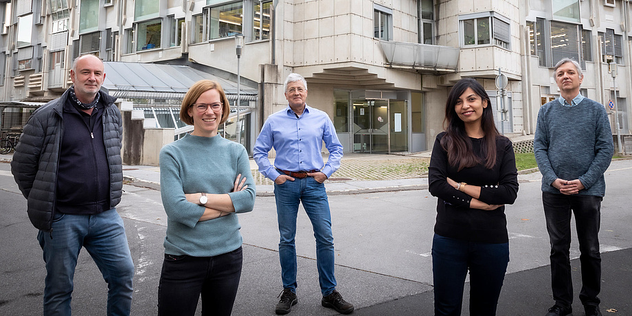 Group of people standing in front of a futuristic building