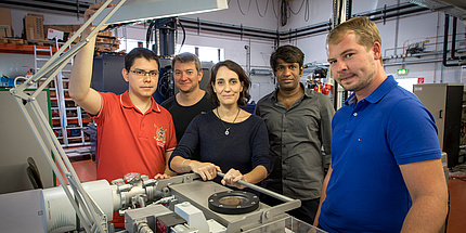 Five persons - one women and four man - are looking at the camera.