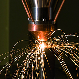 Laser cutter with flying sparks.