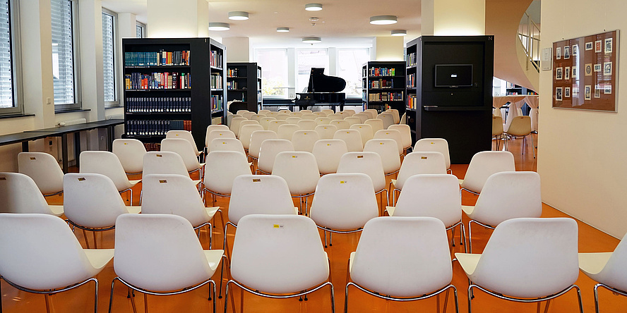 Library with rows of chairs and a piano