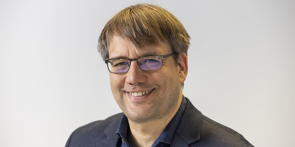 A man smiles into the camera.