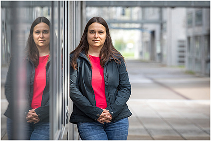 TU Graz researcher in front of an institute building