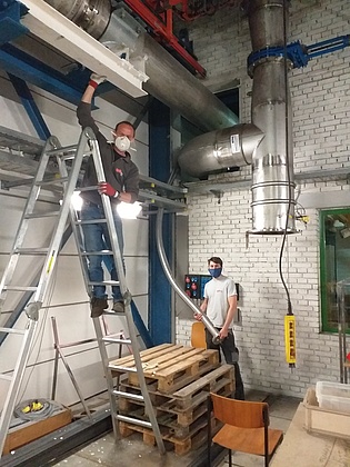 On April 20 we resumed the work in our laboratories in strict adherence to Corona safety regulations.  Martin Haubenhofer and Florian Plank mount the piping for our new wind tunnel wearing face protection masks.