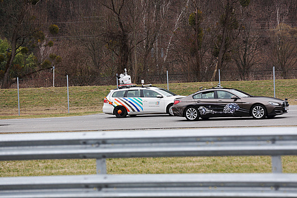 Two research cars on a test track