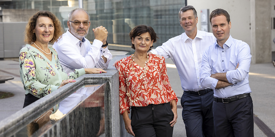 Two women and three men are looking in the camera. 