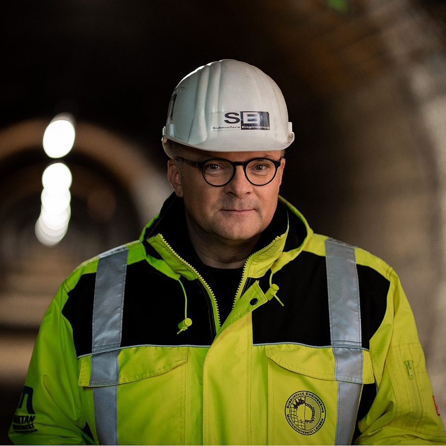 Robert Galler with white helmet and neon yellow jacket in a tunnel