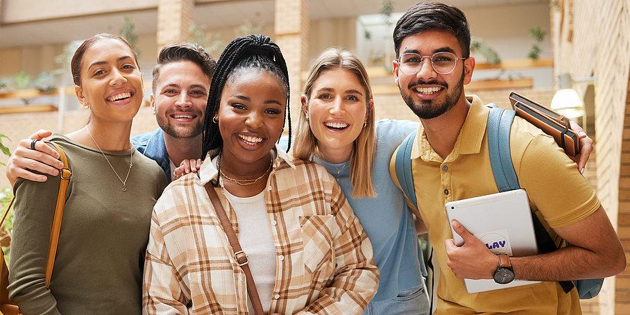 Five smiling university students