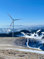Snowy mountain with wind power plant.