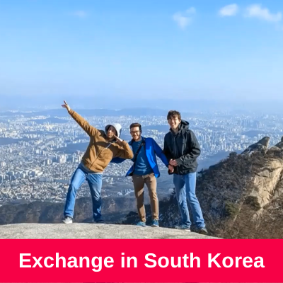 3 people standing on a mountain with a beautiful view