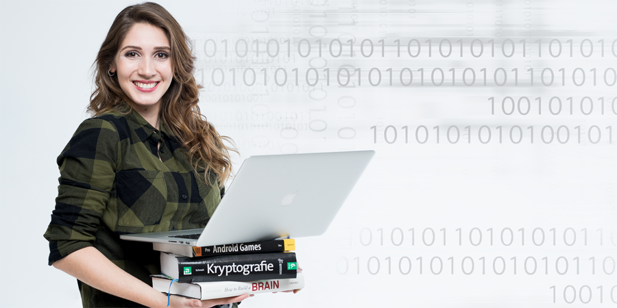 Young woman holds a stack of books with an open laptop on top.