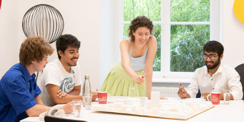 People sit around a table and work together